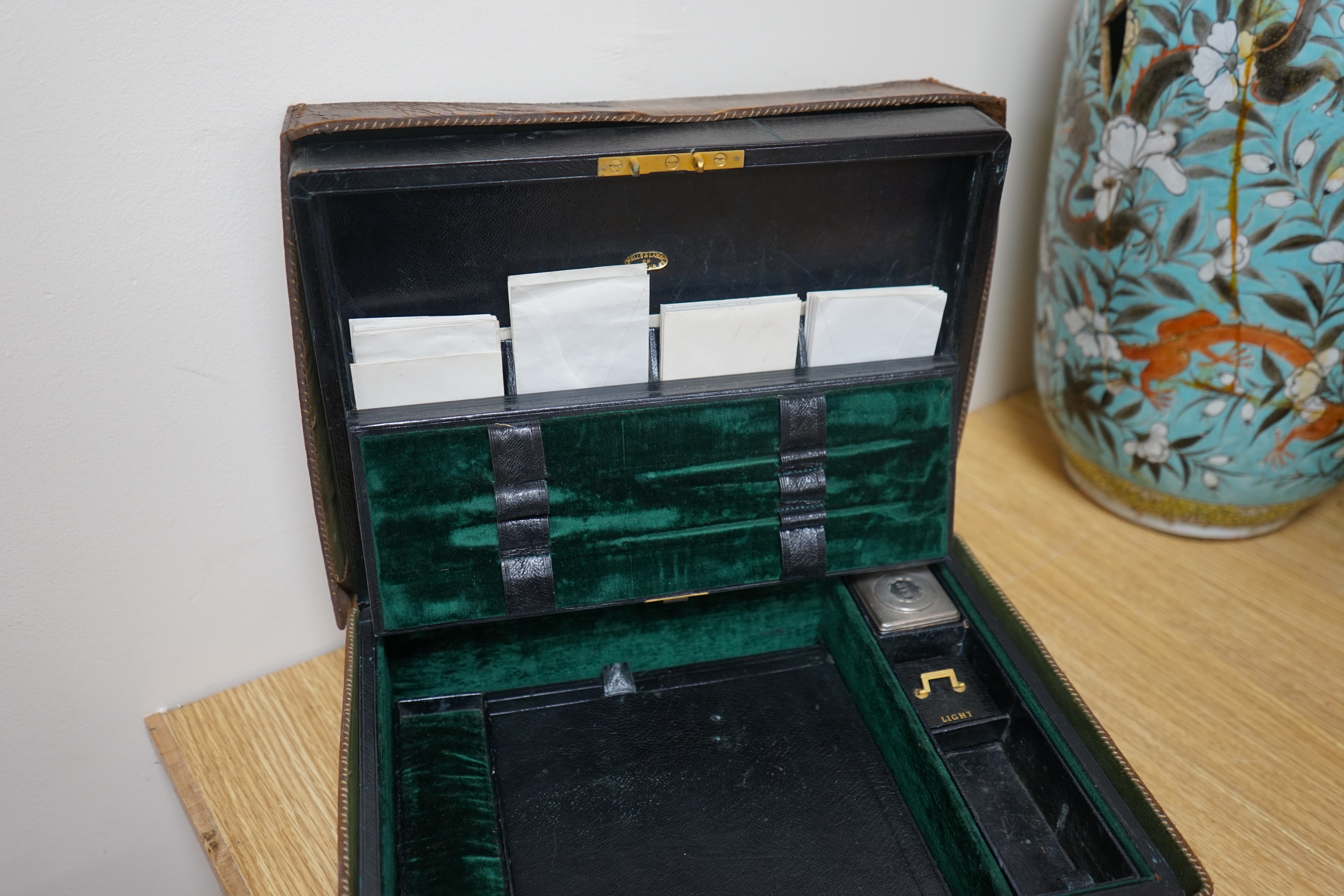 Wells & Lambert, London, a travelling writing box and outer leather case, with Bramah lock and keys, with monograms and inscriptions of Rev. George A. Robins, the box incorporating a silver lidded inkwell, 33cm wide. Con